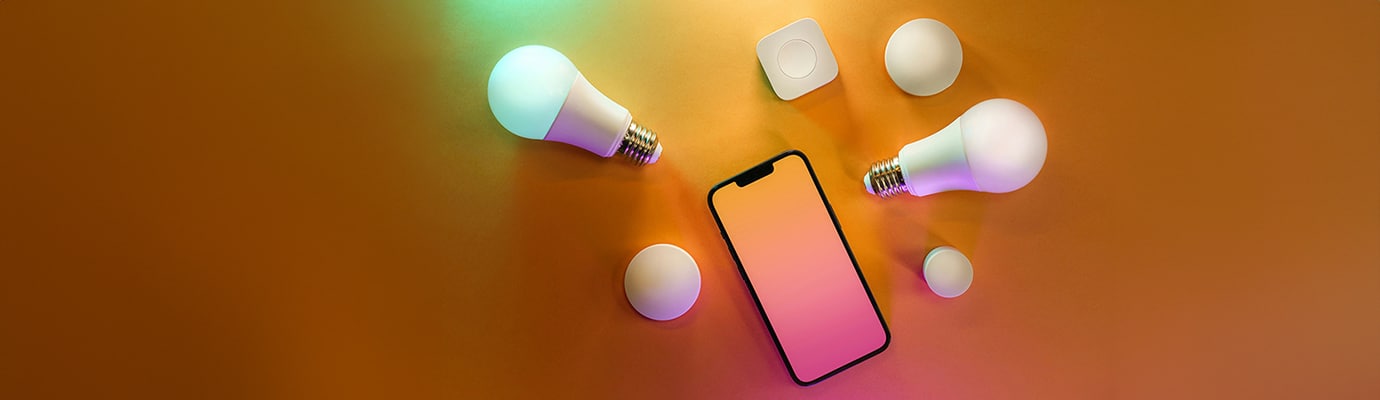 Cell phone and light bulbs on an orange background