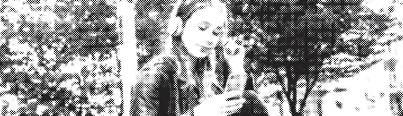 alienated black-and-white photo: young woman with headphones looking at her smartphone.