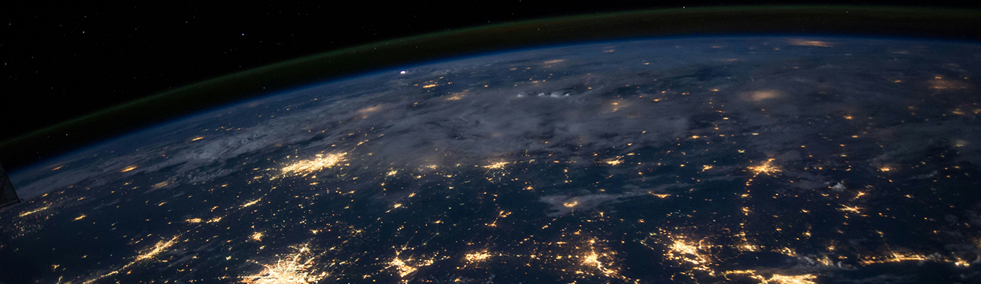 View from space of Earth at night, with cities that are illuminated