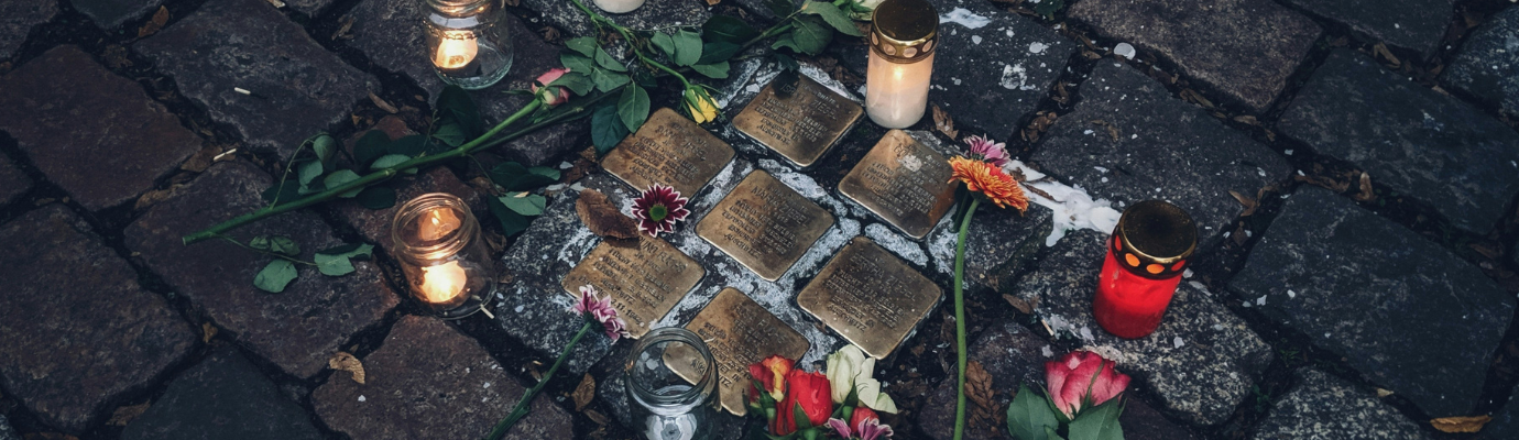 stumbling blocks with lit candles and roses