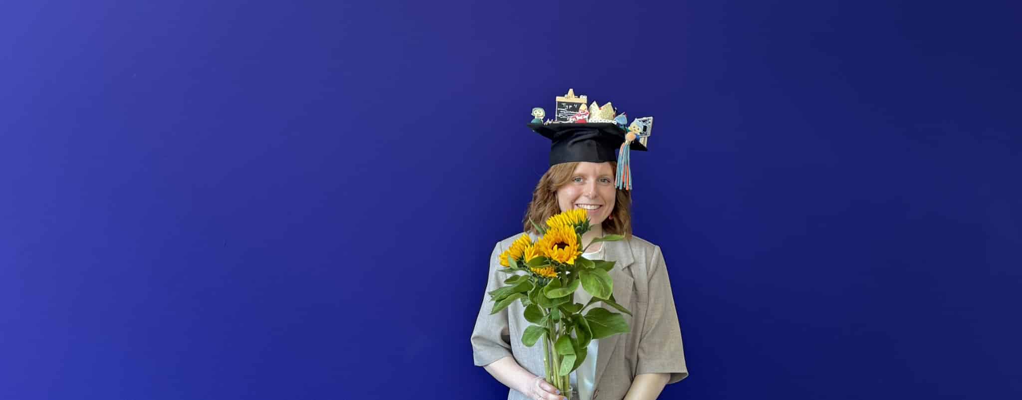 Kira Thiel with a graduation cap and flowers