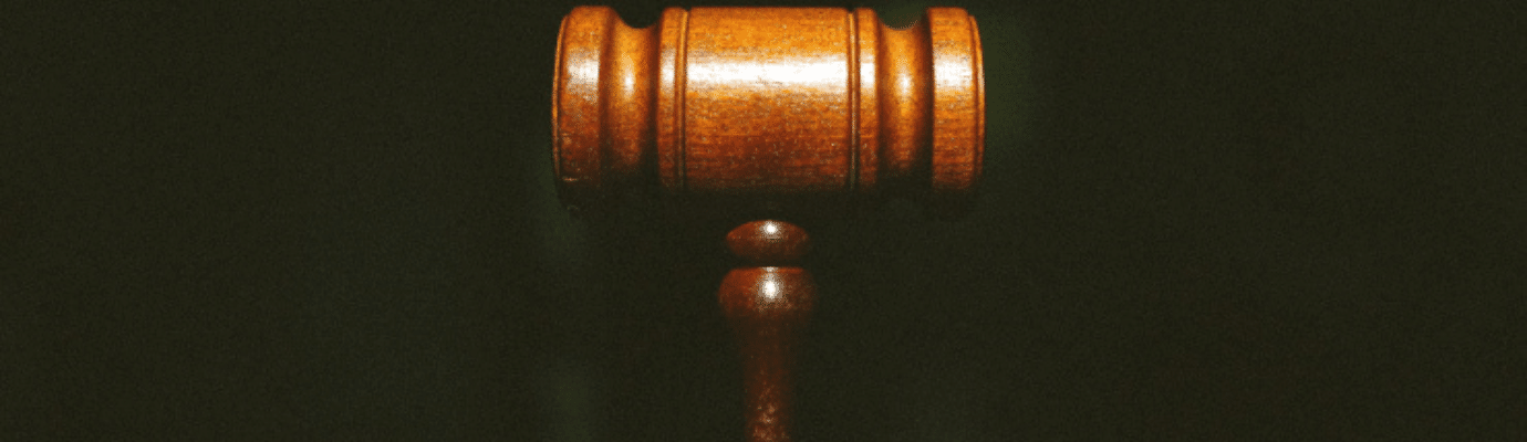 Wooden judge's gavel against a dark background