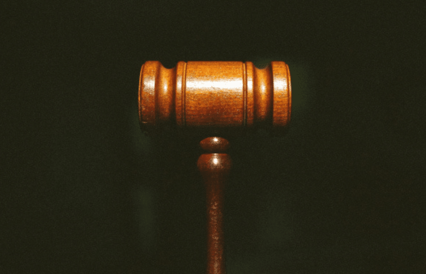 Wooden judge's gavel against a dark background