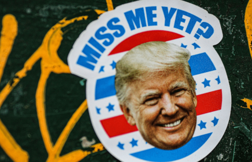 Sticker showing a smiling man's face with the text 'MISS ME YET?' against a green background with yellow graffiti.